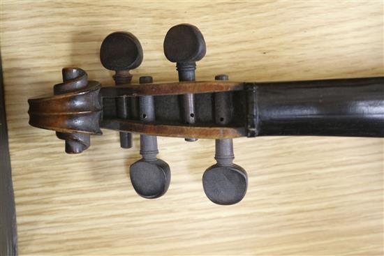 A violin, bow and a mother of pearl inlaid mandolin